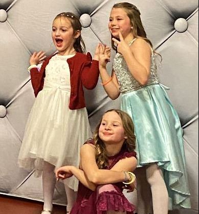 3 girls posing for a picture at the Princess Dance