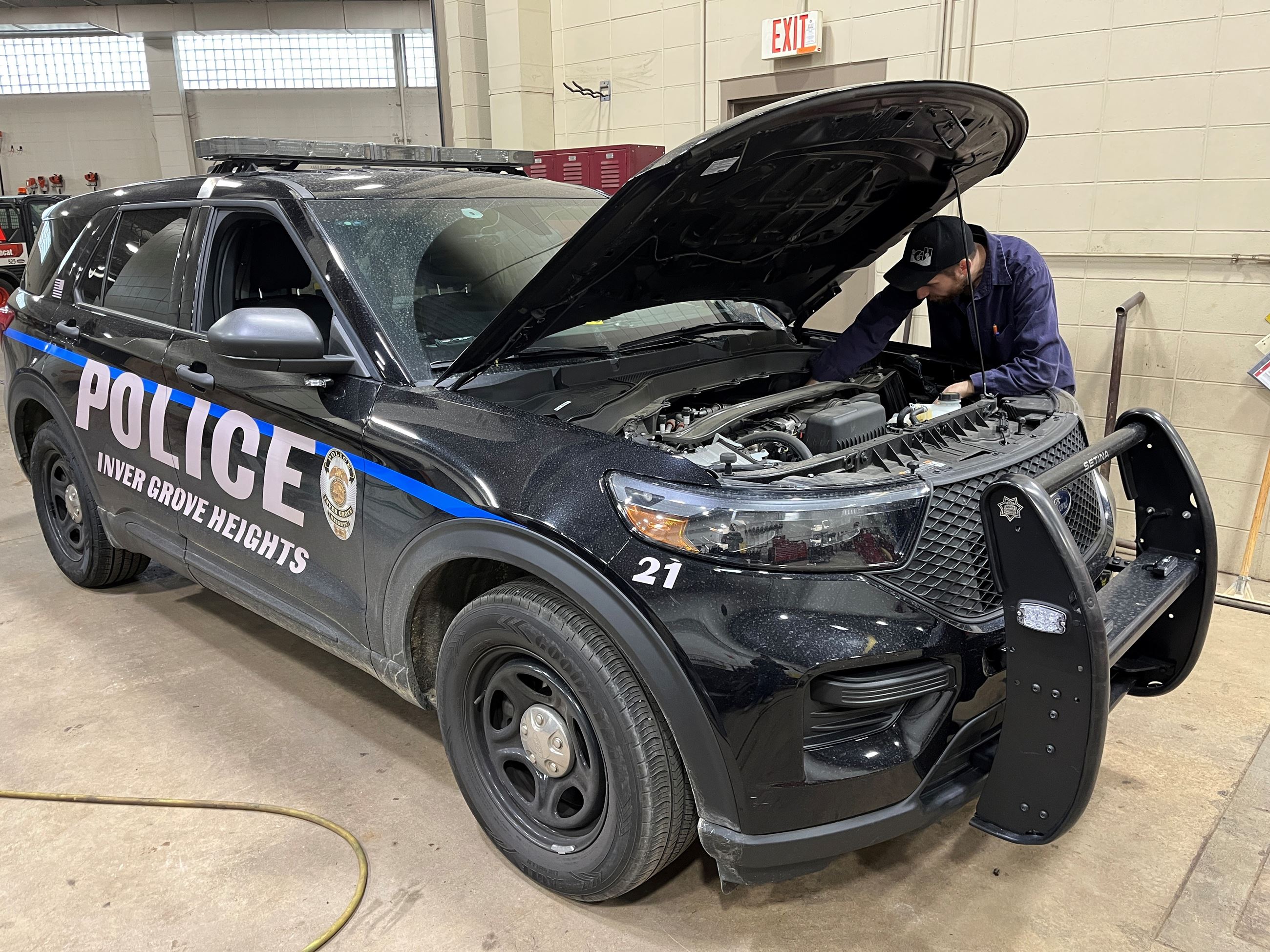 Checking under the hood of a Police Car